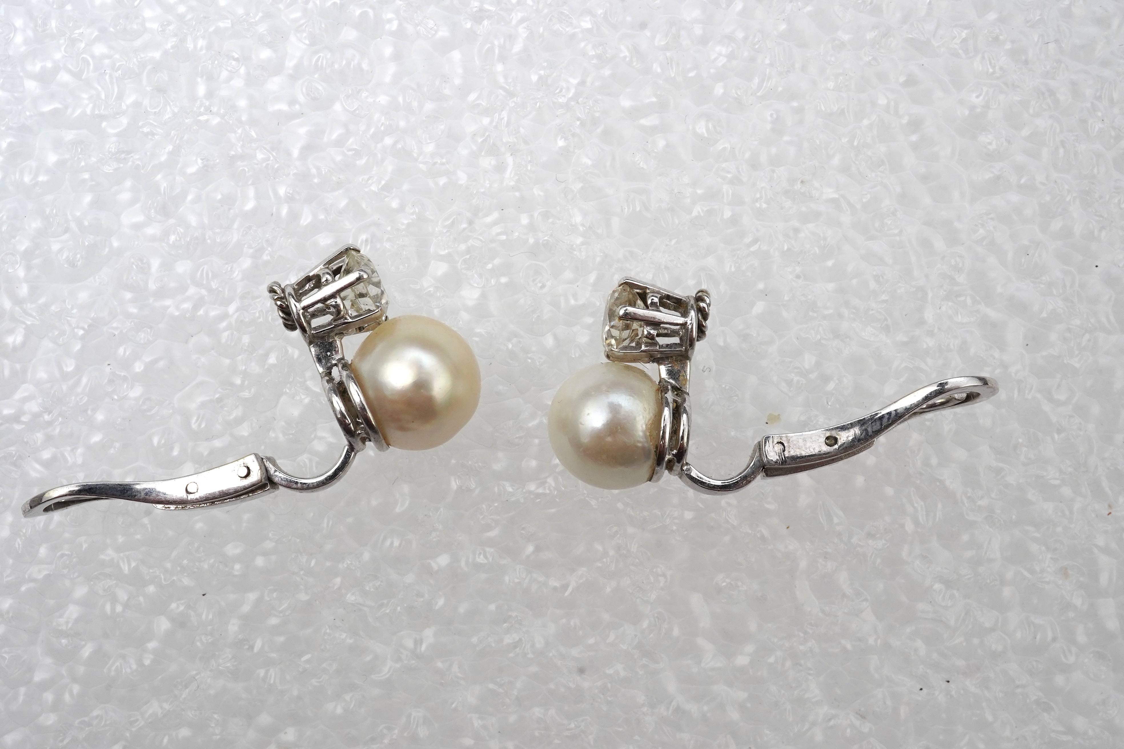 A pair of pearl and diamond ear clips, mid 20th century